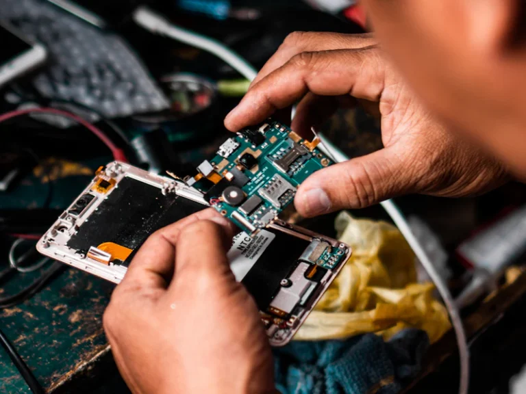 Technician repairing an AC circuit board (PCB)